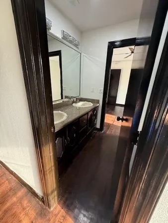a view of bathroom with a sink and mirror