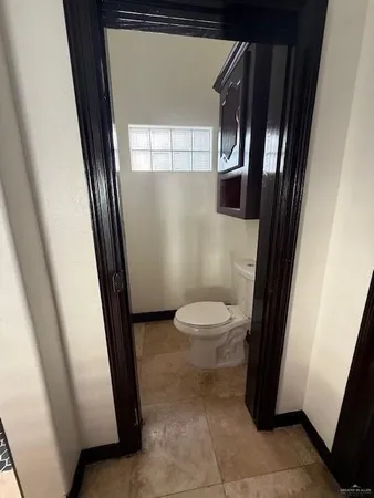 a bathroom with a toilet and a mirror