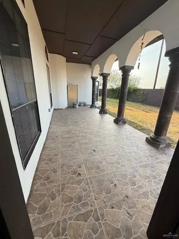 a view of a room with wooden floor and windows