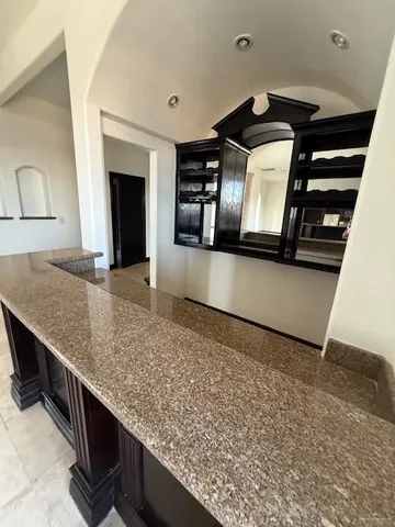 a view of a kitchen with a sink and fireplace