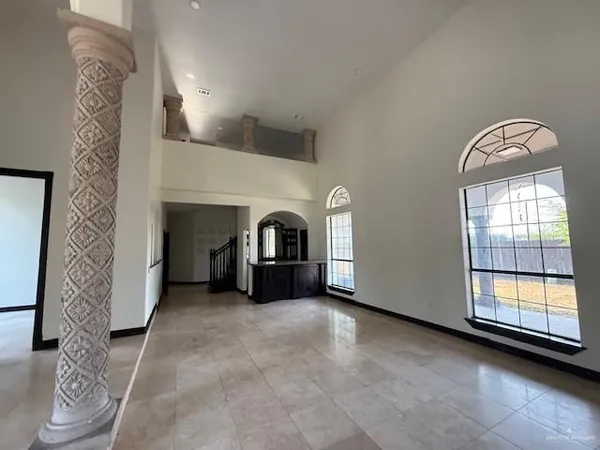 a view of an empty room with a fireplace and a window