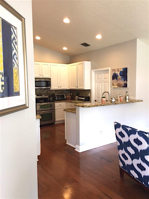 394 Mallard Point Jupiter, FL 33458 - Photo 9 of 16 a kitchen with stainless steel appliances kitchen island granite countertop a stove a sink and a microwave