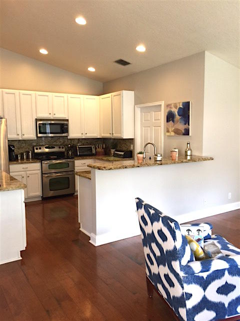 394 Mallard Point Jupiter, FL 33458 - Photo 10 of 16 a kitchen with stainless steel appliances granite countertop a sink and microwave
