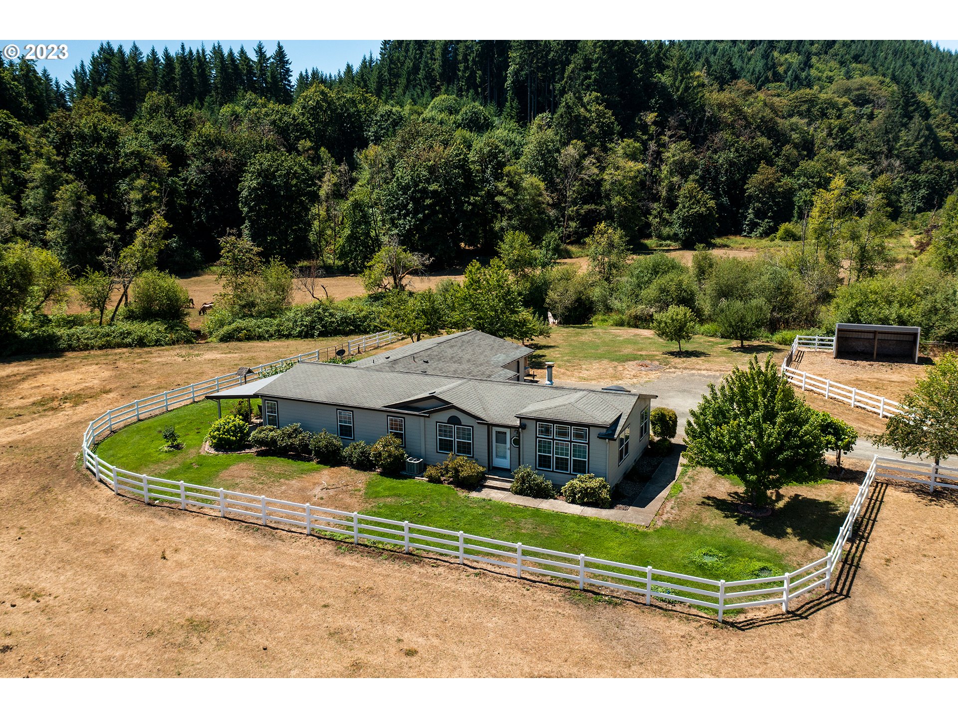 an aerial view of a house with a yard basket ball court and outdoor seating