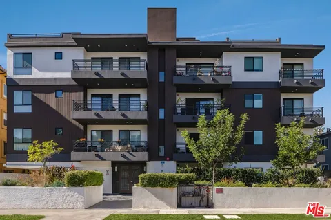 a front view of a house with lots of trees