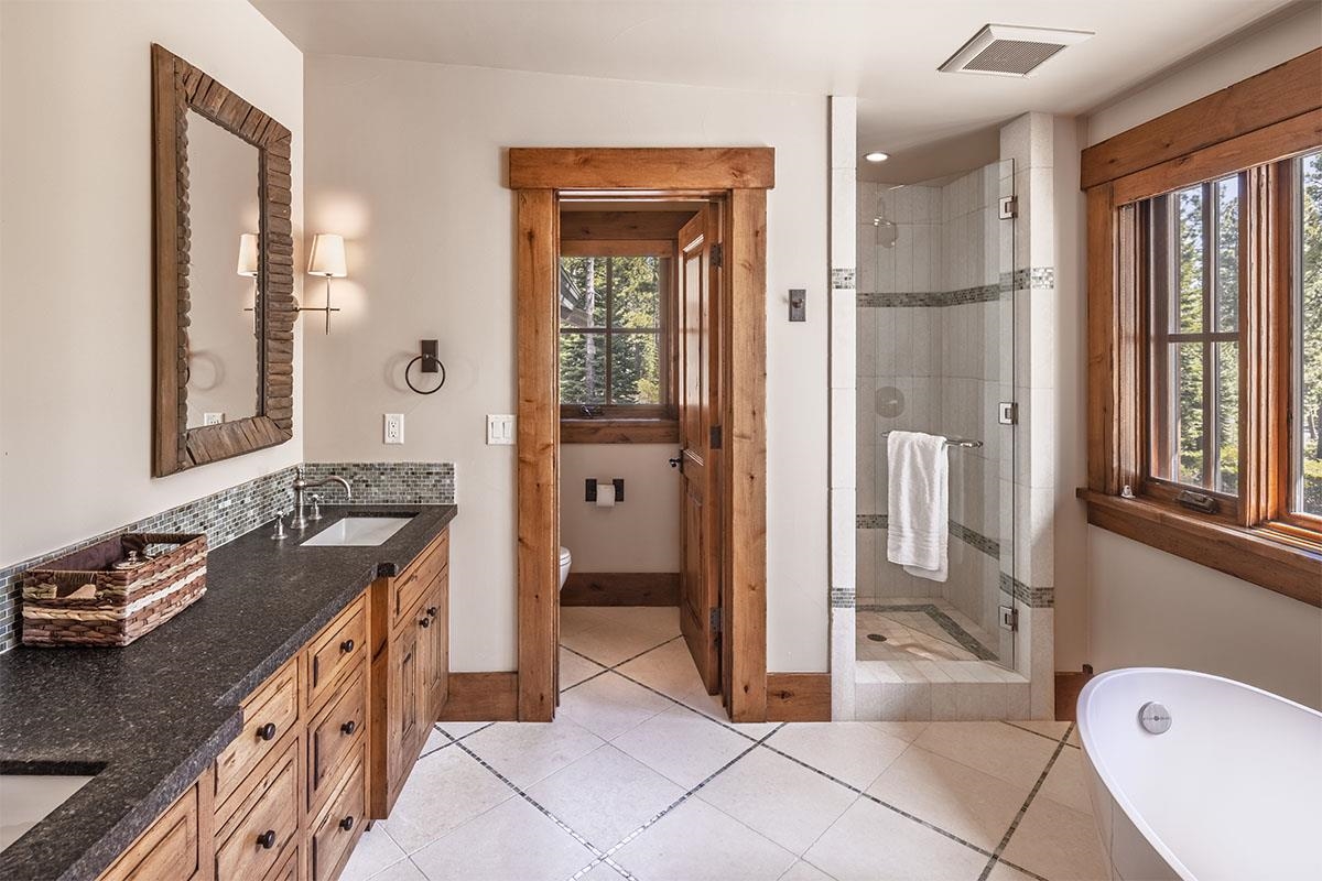 8186 Valhalla Drive Truckee, CA 96161 - Photo 20 of 28 a spacious bathroom with a granite countertop sink and a mirror
