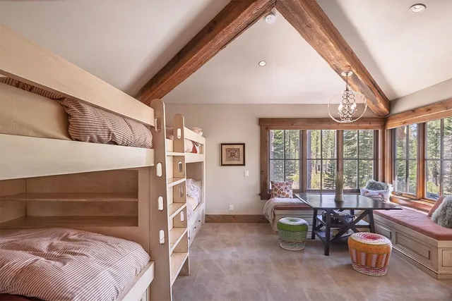 a bedroom with furniture and a large window