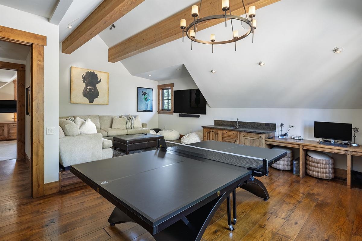 8186 Valhalla Drive Truckee, CA 96161 - Photo 25 of 28 a living room with a table chairs and a wooden floor