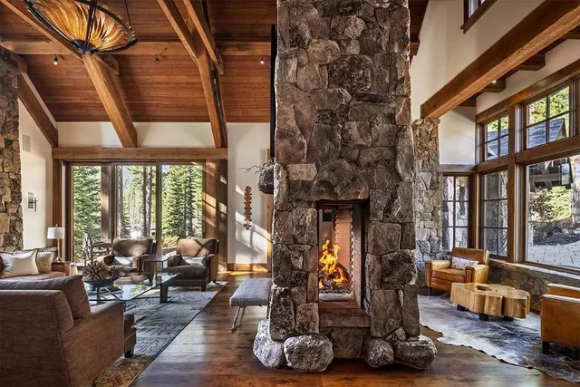 a living room with furniture a rug and a large window