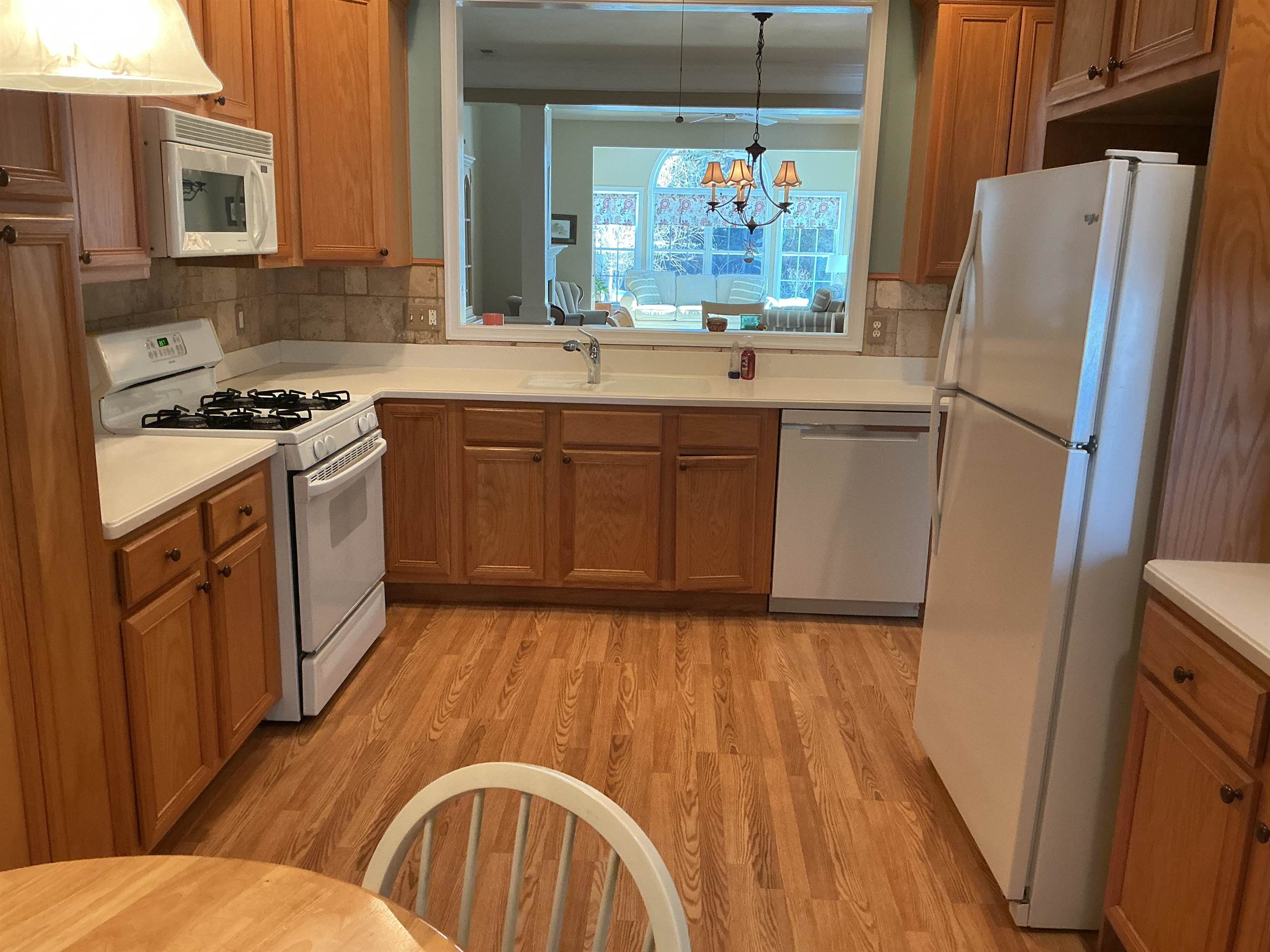 1731 Highway 9, Unit 25 Ocean View, NJ 08230 - Photo 3 of 21 a kitchen with a sink a refrigerator a stove a microwave and island