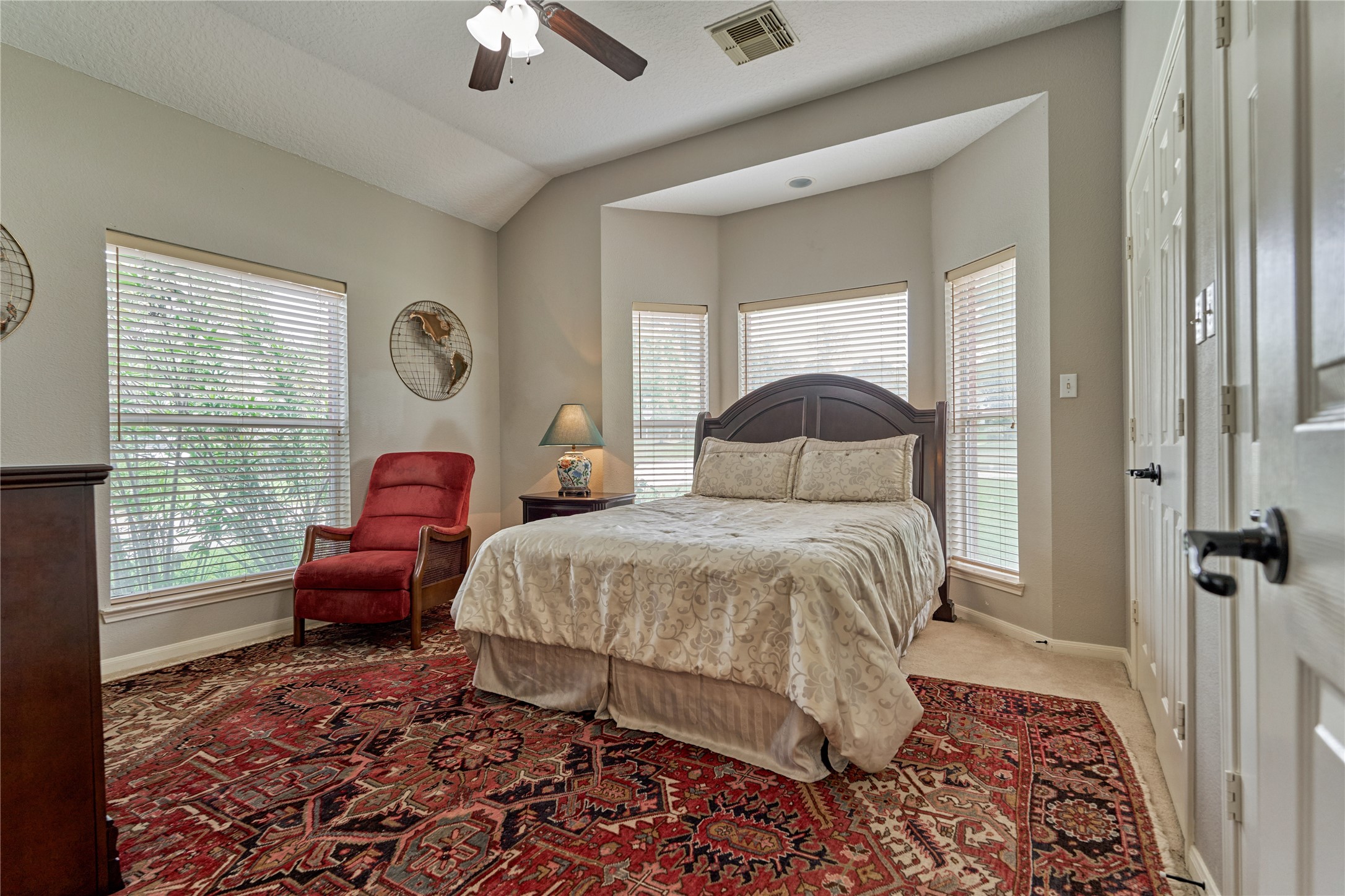 197 Monterrey Road East Montgomery, TX 77356 - Photo 25 of 50 There are two secondary bedrooms located down a private hall, offering a quiet and comfortable retreat. Each bedroom features dual closets that connect to create an expansive storage space. Secondary bedroom #1 includes a charming bay window that frames lovely views of the front yard, filling the room with natural light.