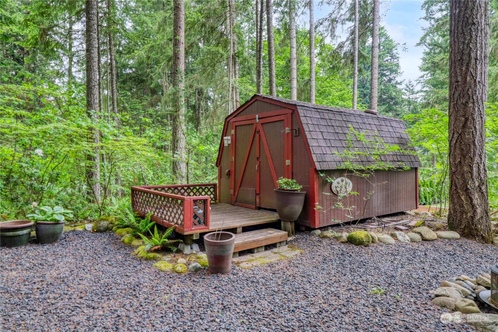 18114 Rampart Drive Southeast Yelm, WA 98597 - Photo 32 of 38 a wooden bench sitting in the middle of a forest