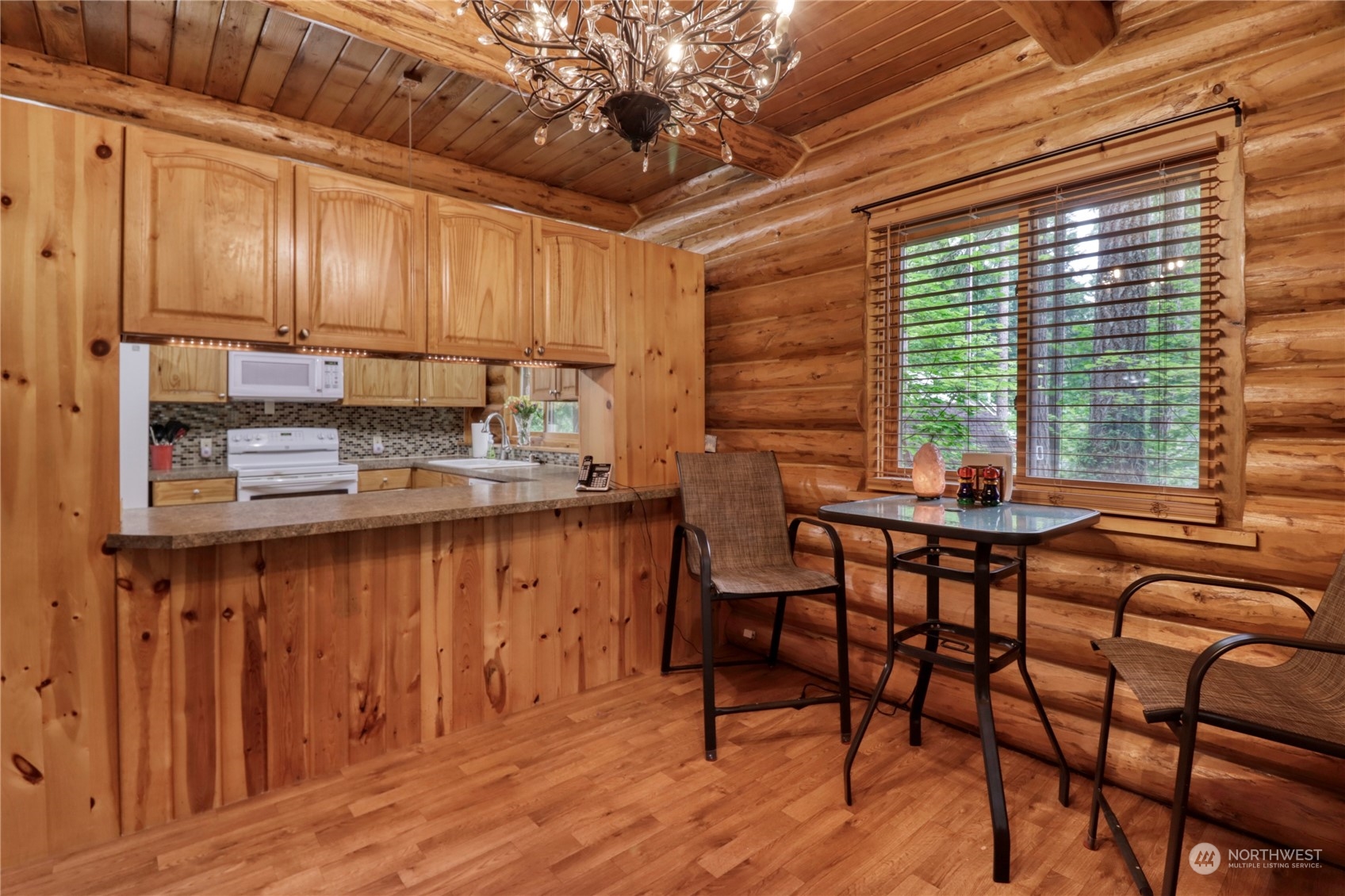 18114 Rampart Drive Southeast Yelm, WA 98597 - Photo 8 of 38 a kitchen with stainless steel appliances granite countertop wooden cabinets a table and chairs