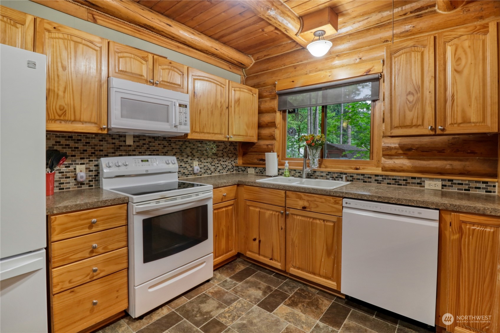 18114 Rampart Drive Southeast Yelm, WA 98597 - Photo 10 of 38 a kitchen with stainless steel appliances granite countertop a stove a sink and a microwave