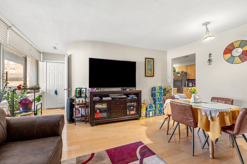 1002 Paradise Road, Unit 1O Swampscott, MA 01907 - Photo 3 of 23 a living room with furniture and a flat screen tv