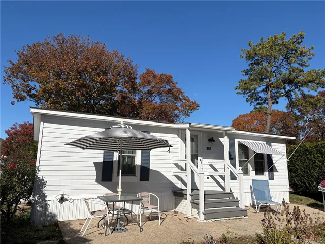a view of a patio with table and chairs and potted plants