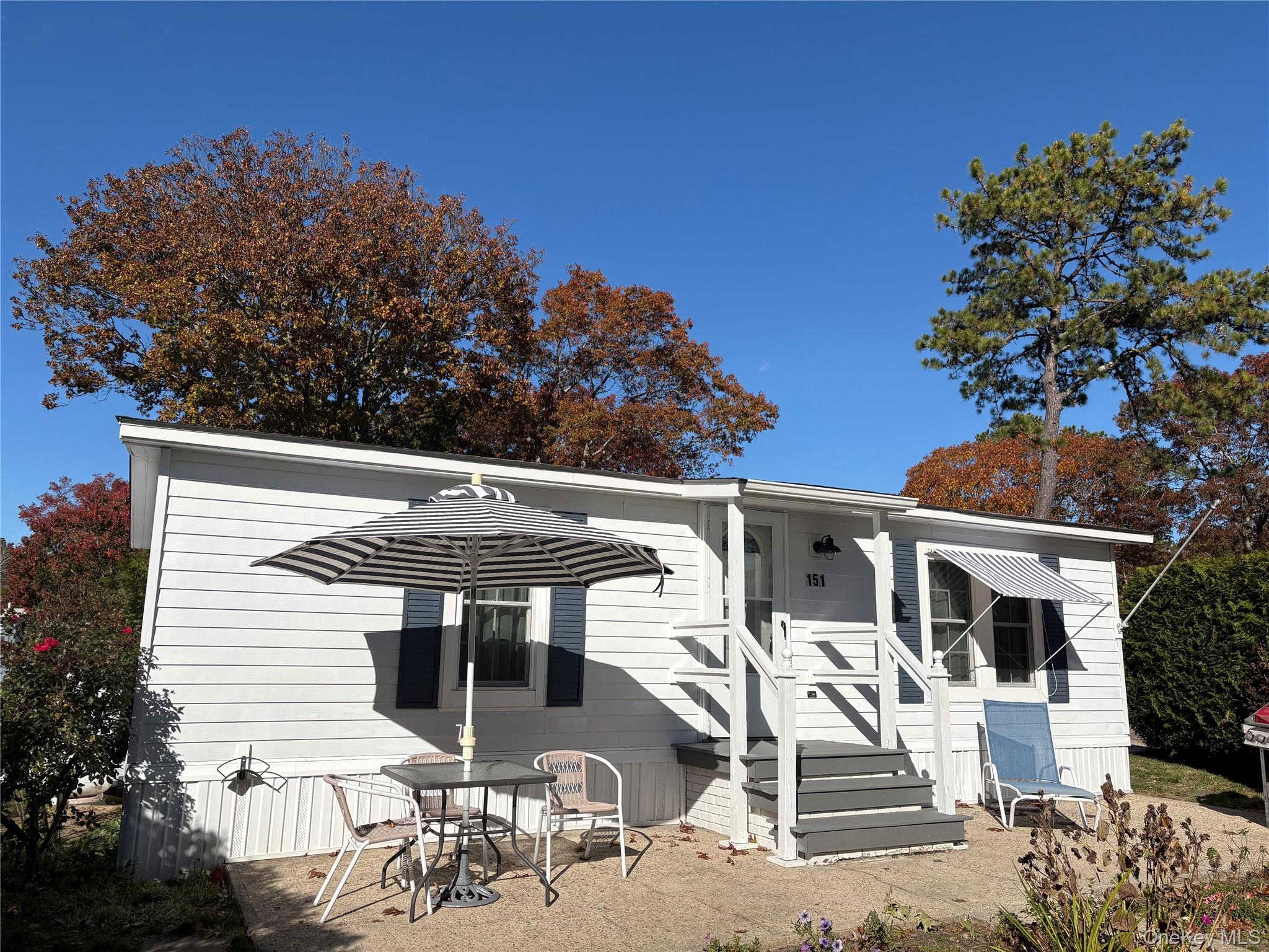 a view of a patio with table and chairs and potted plants
