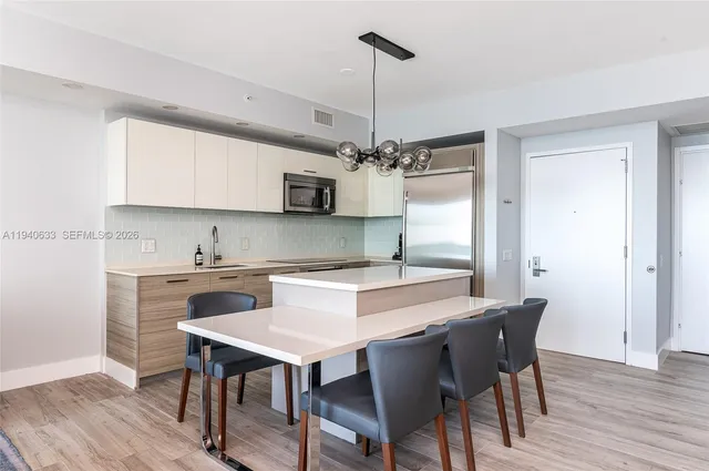 a kitchen with a table and chairs in it