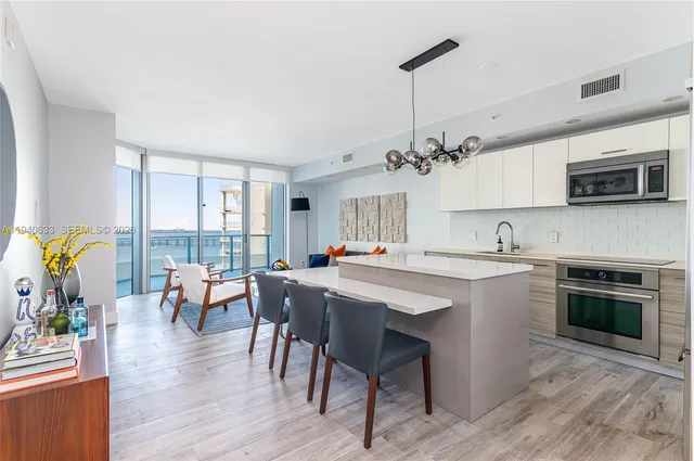 a kitchen with a table chairs stove and microwave