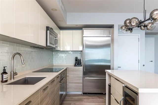 a kitchen with a sink cabinets and stainless steel appliances