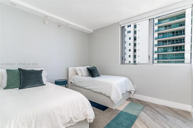 a bedroom with two beds and a window