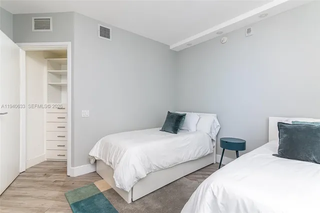 a bedroom with two beds and painted walls