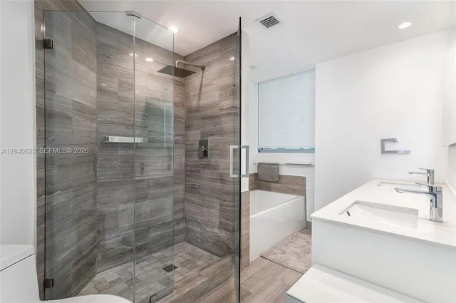 a bathroom with a shower and a sink