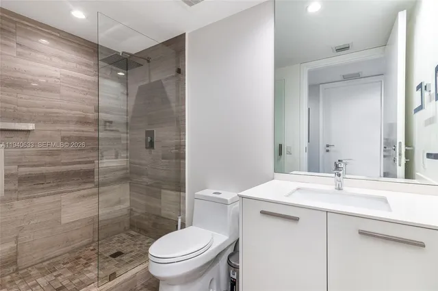 a bathroom with a sink toilet and shower