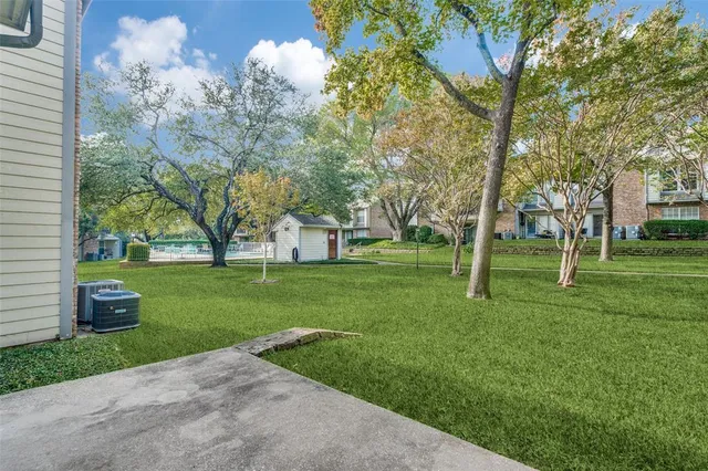 a huge green field with lots of trees