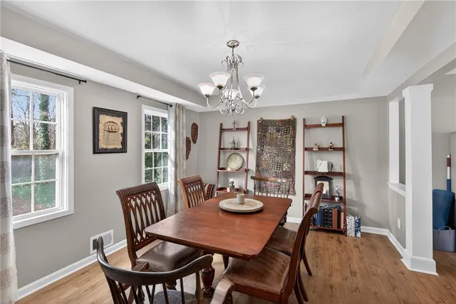 a view of a dining room with furniture and chandelier