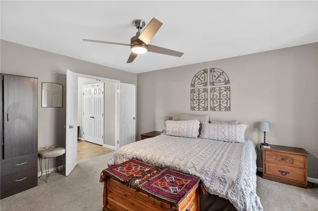 a bedroom with a bed and a lamp on the dresser