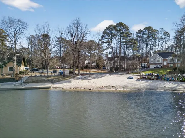 a view of water with boats and trees in the background