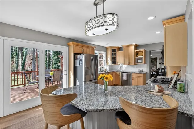 a view of living room with granite countertop kitchen island furniture and a large window