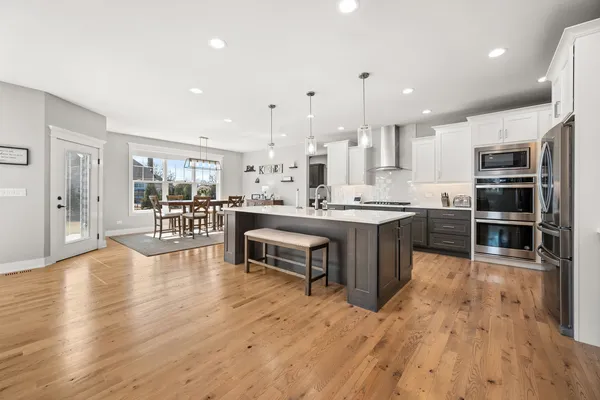 a living room with couches and kitchen view