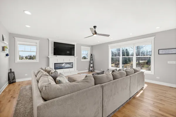 a large kitchen with stainless steel appliances kitchen island a large counter top and a view of living room