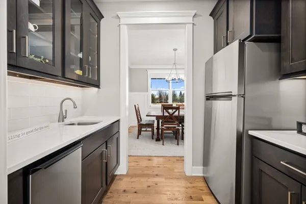 a bathroom with a granite countertop sink and a toilet