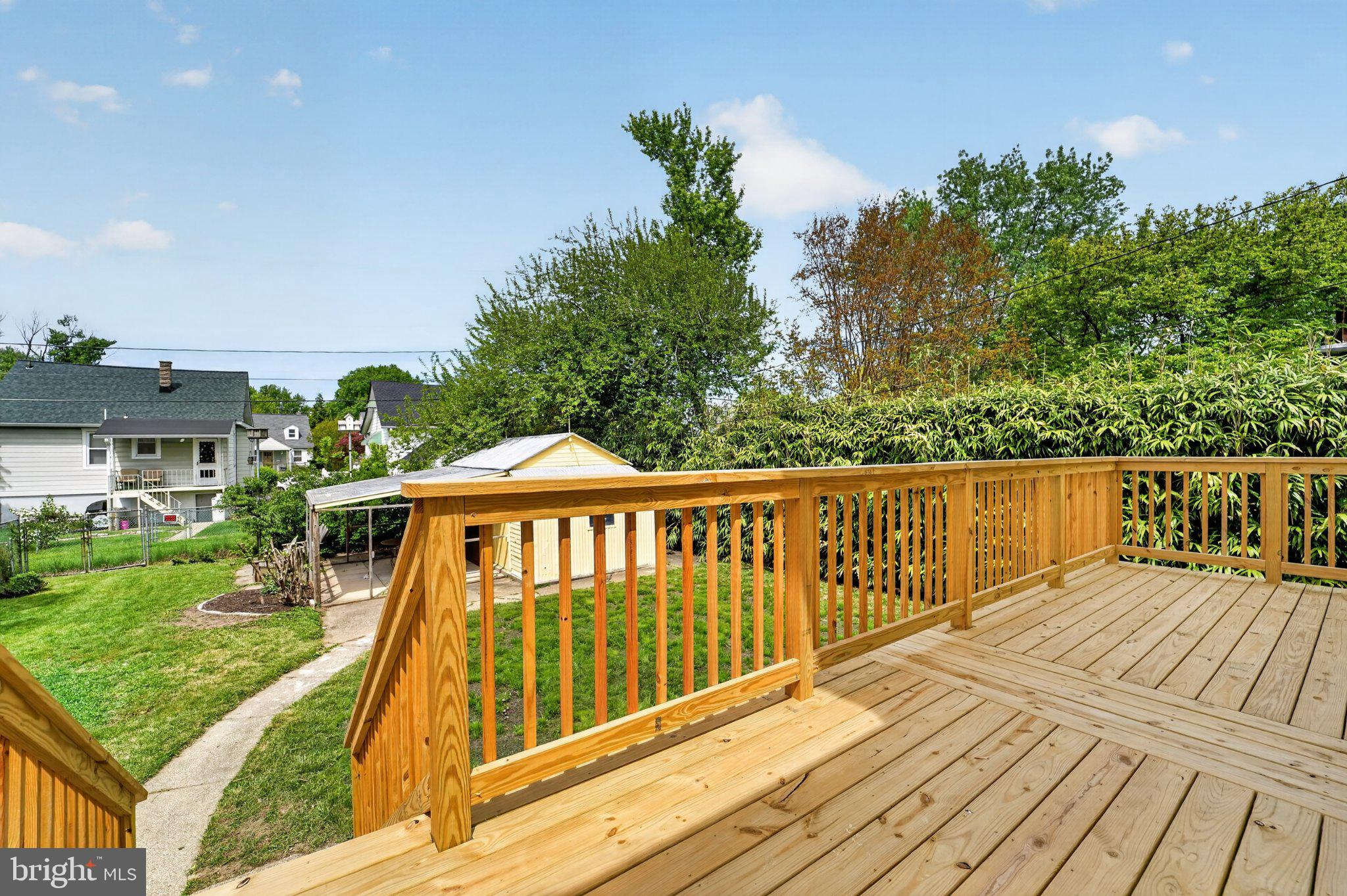 5312 Catalpha Road Baltimore, MD 21214 - Photo 6 of 59 a balcony with wooden floor and yard in the back