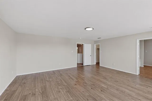 a view of an empty room and wooden floor