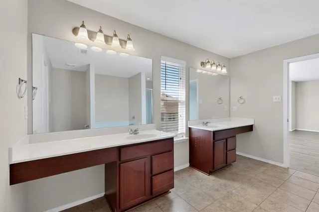 a spacious bathroom with a double vanity sink mirror and double