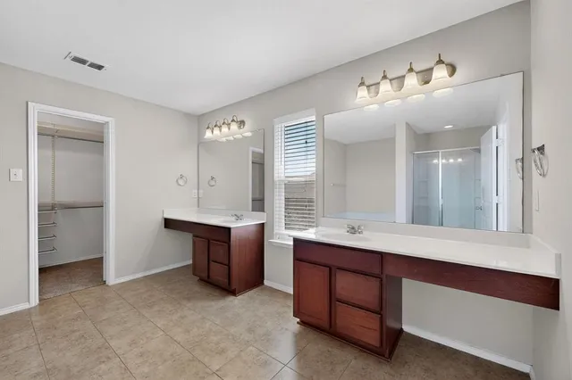 a bathroom with a sink double vanity and a tub