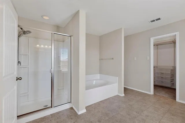 a bathroom with a bathtub and a shower