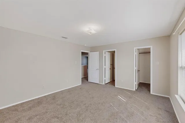 a view of an empty room and closet area