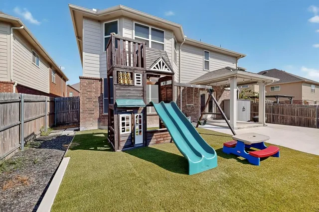 a view of a house with swimming pool and sitting area