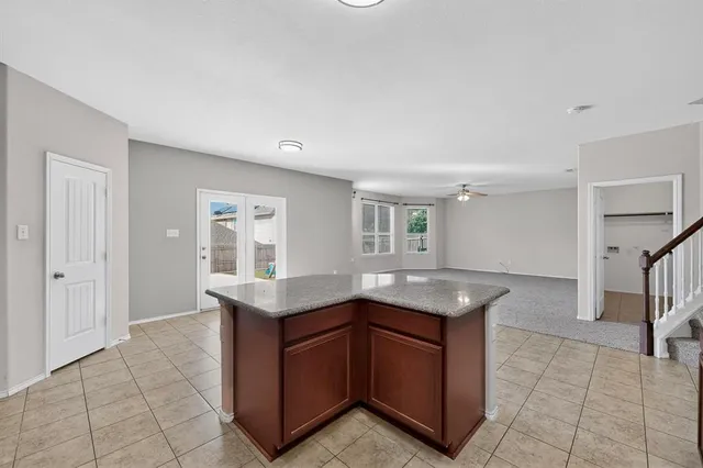 a kitchen with granite countertop a sink and a stove