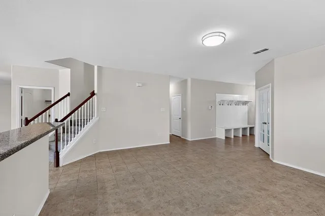 a view of empty room with stairs