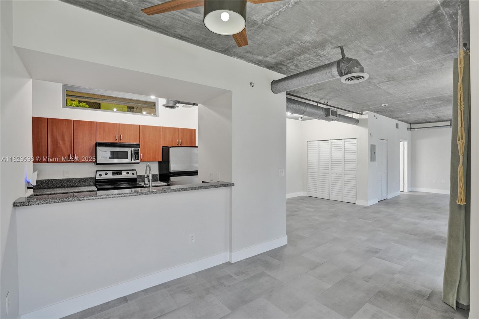 455 Northeast 25th Street, Unit 609 Miami, FL 33137 - Photo 15 of 27 a kitchen with stainless steel appliances a sink and a refrigerator