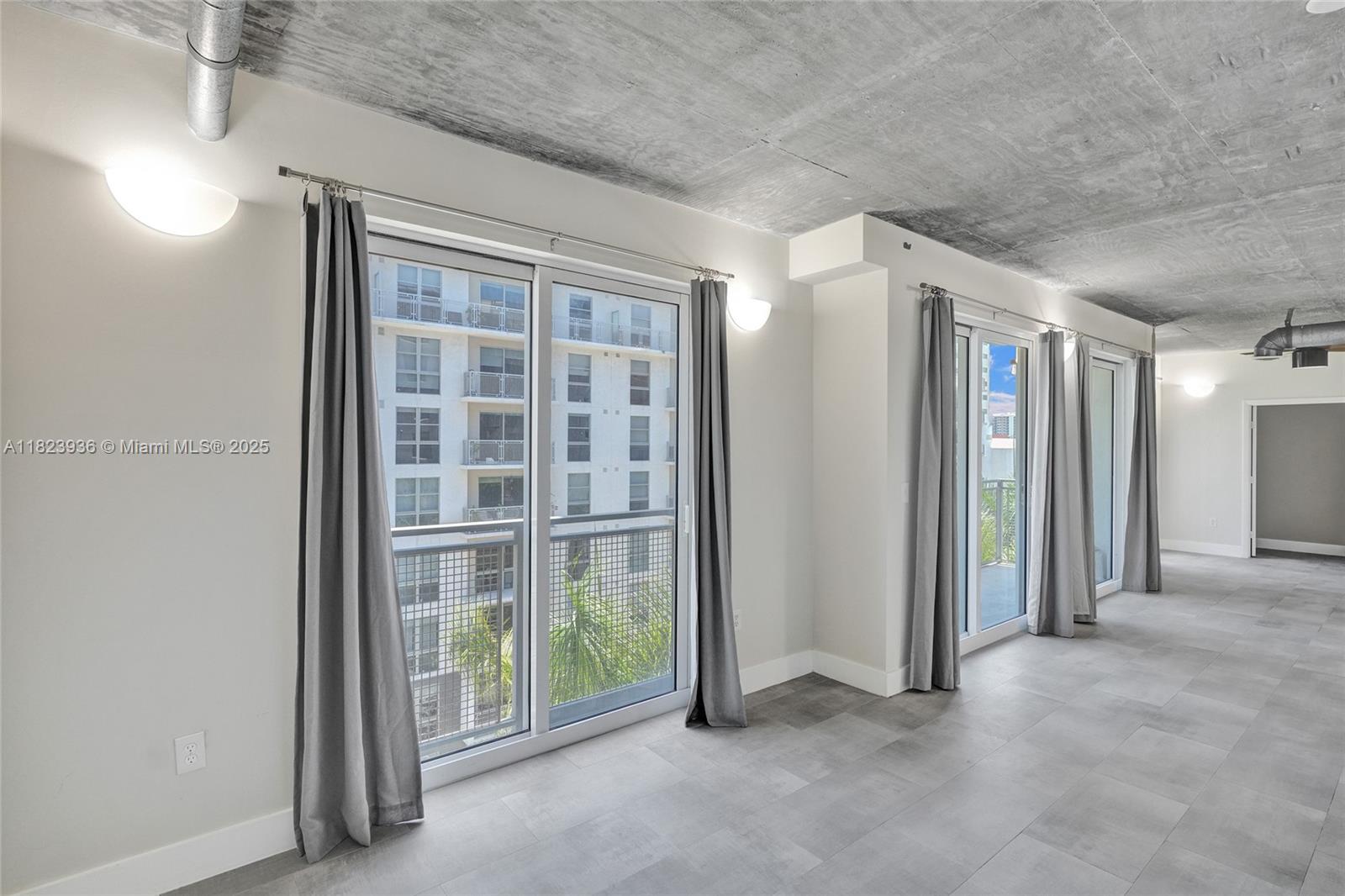 455 Northeast 25th Street, Unit 609 Miami, FL 33137 - Photo 18 of 27 an empty room with windows