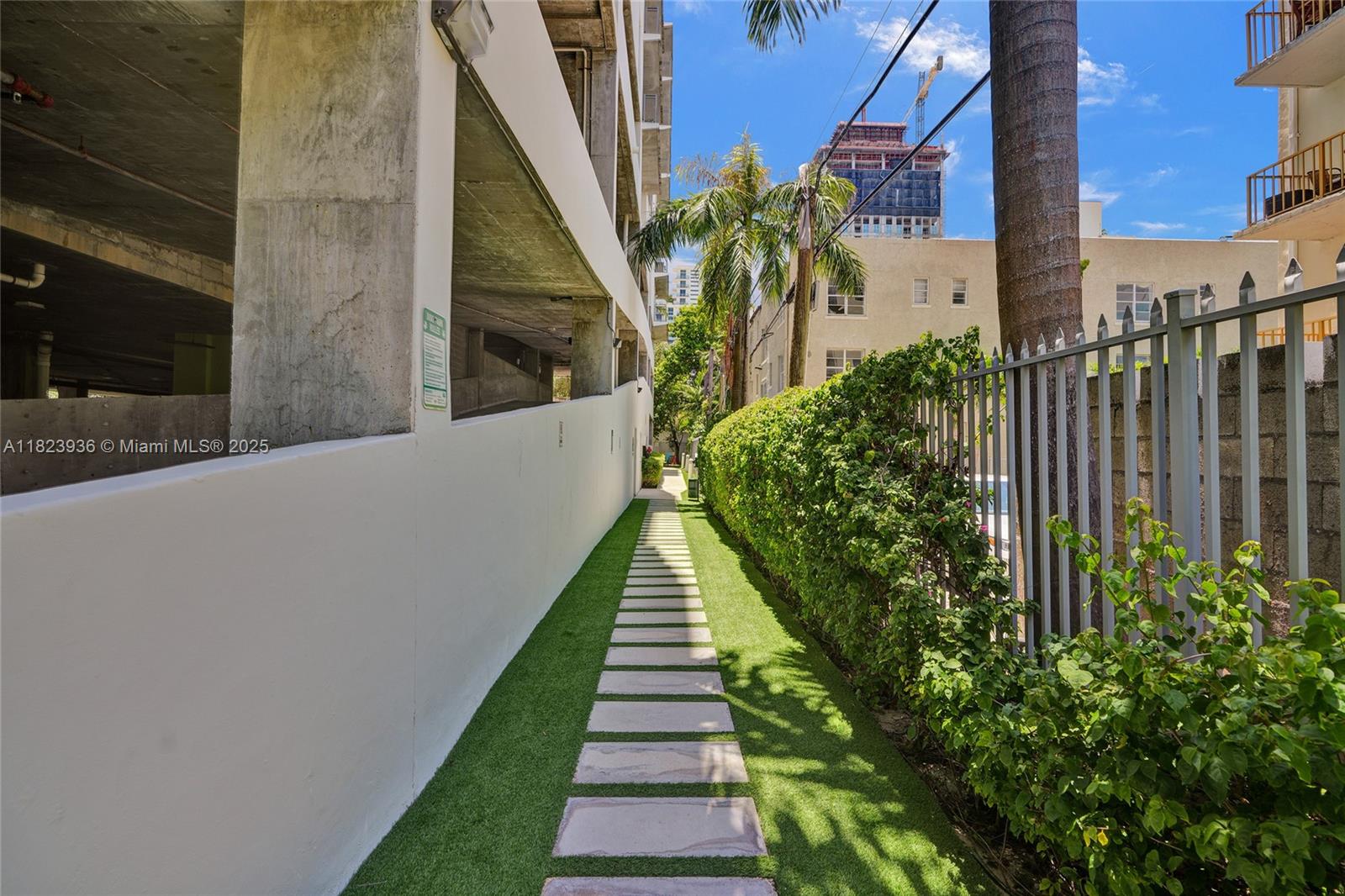 455 Northeast 25th Street, Unit 609 Miami, FL 33137 - Photo 23 of 27 a view of a pathway of a house with a yard