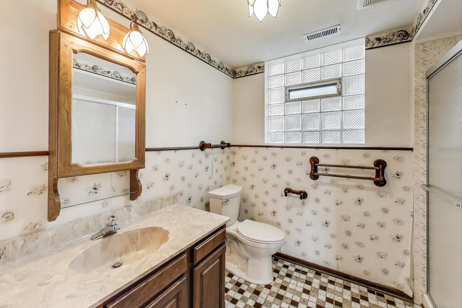 700 Noah Terrace Mount Prospect, IL 60056 - Photo 15 of 35 a bathroom with a sink toilet a mirror and shower