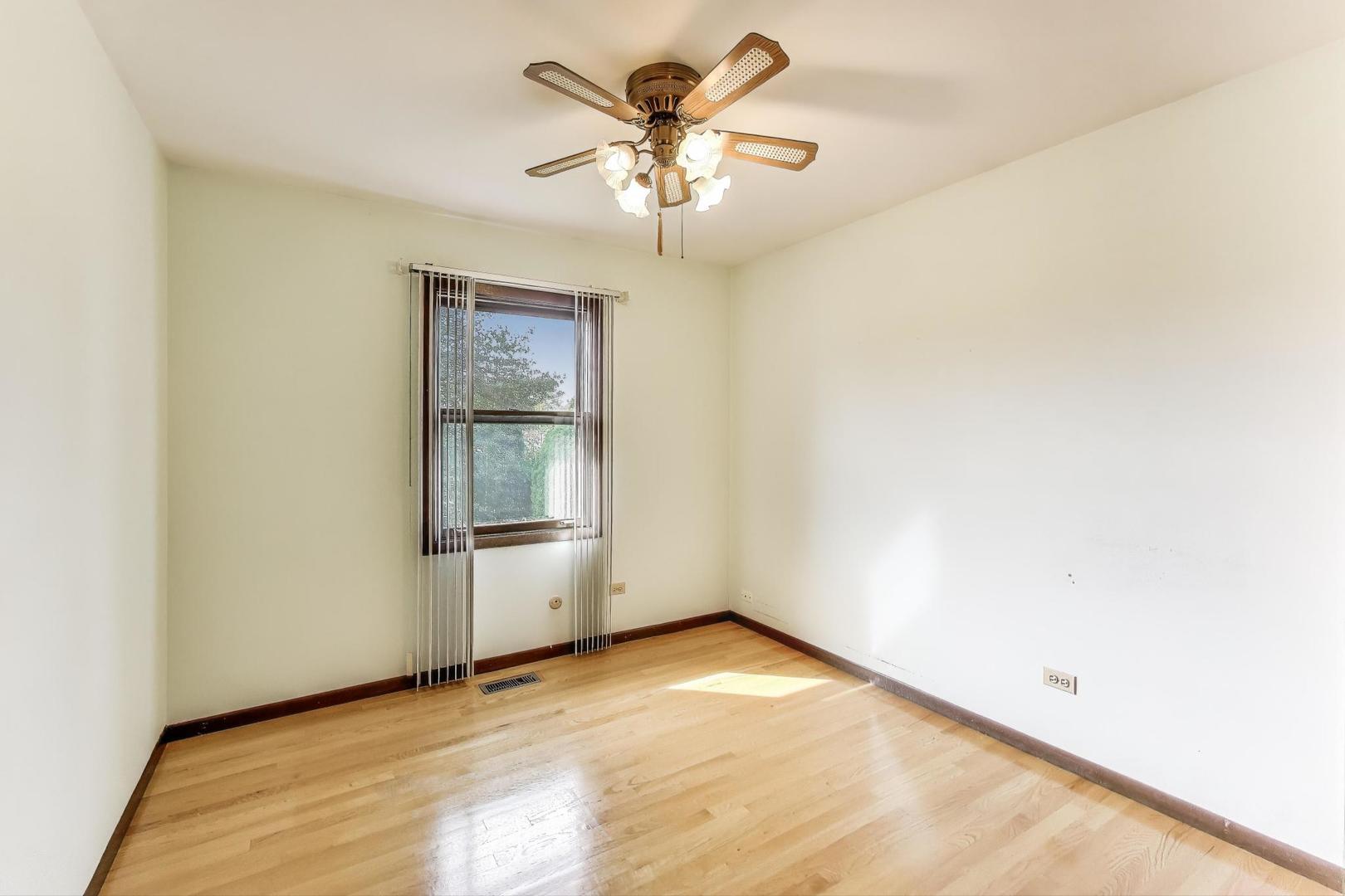 700 Noah Terrace Mount Prospect, IL 60056 - Photo 21 of 35 an empty room with a window and a ceiling fan